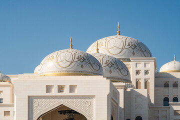 UAE Presidential Palace Qasr Al Watan, Palace of the Nation. Large majestic white domes with golden ornaments close-up view.