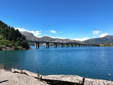 Bridge over a mountain lake in the town of Riano in Spain
