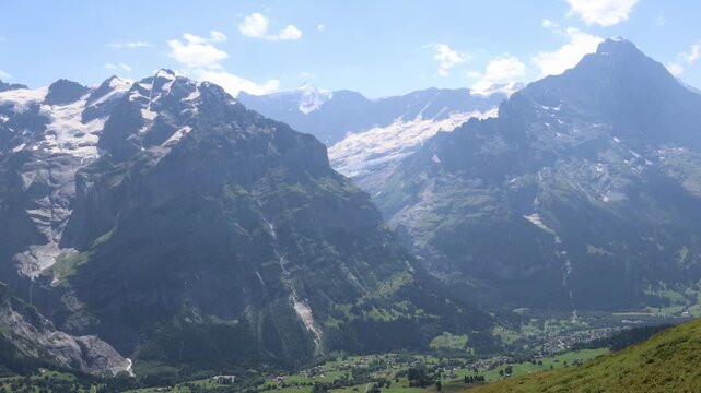 Eiger and Mettenberg mountain rising above village of Grindelwald in Switzerland