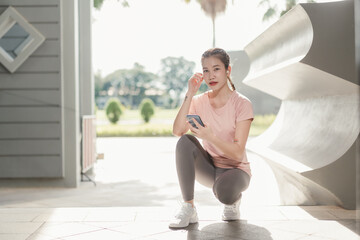 Asian woman athlete with earphones for music, radio or podcast for motivation. Fitness, energy and athlete runner doing outdoor cardio workout for good health.