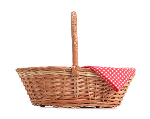 One picnic wicker basket with checkered napkin isolated on white