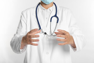 Doctor holding something on white background, closeup