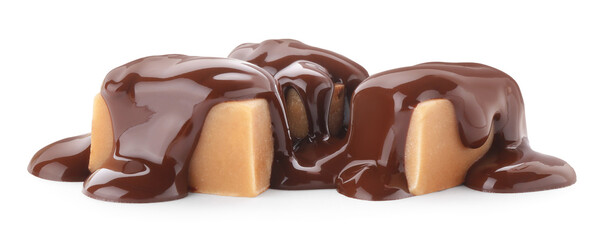Delicious caramel candies with melted chocolate isolated on white