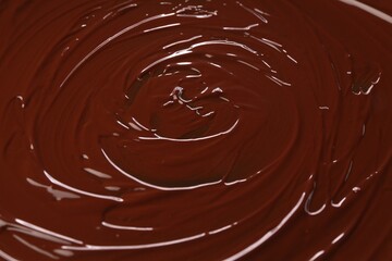 Delicious melted chocolate as background, closeup view