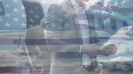 American flag animation overlaying business people using smartphones outdoors - Powered by Adobe
