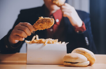 close up focus woman hand hold fried chicken for eat,girl with fast food concept