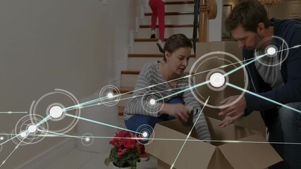 Network of connections animation over people unpacking boxes in new home