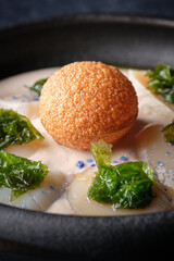 Bowl with cream soup and fried cheese ball