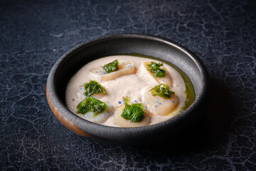 Bowl with delectable fresh cream soup with sea scallop