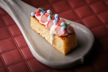Piece of tasty cake with shrimps in white mojo