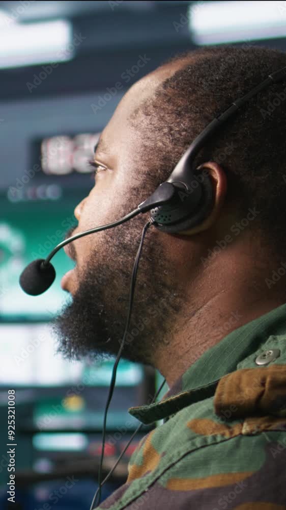 Poster vertical video military dispatcher using headphones microphone, offering information to commanders f