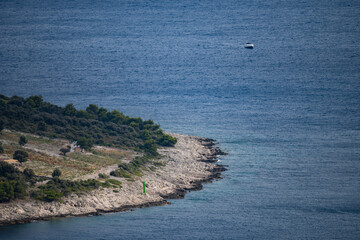 Aerial view of solitary house built on the rough beach near town of Primosten, Croatia on wonderful peninsula in open, adriatic sea