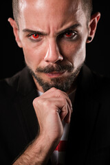 Stern man with piercing gaze in dark backdrop