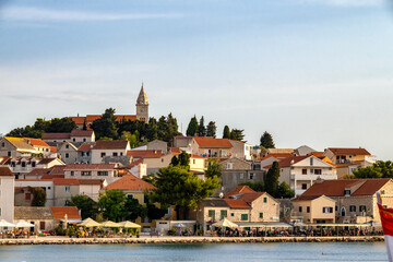 Beautiful, tourist town of Primosten, Croatia with St. George Church on the top of the hill, above small houses