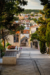 Beautiful, narrow, stone streets and old houses of famous tourist town of Primosten, Croatia at sunset