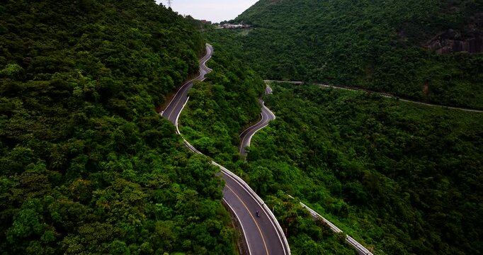Scenic roads on Hai Van Pass snaking through lush mountainous landscape, Vietnam