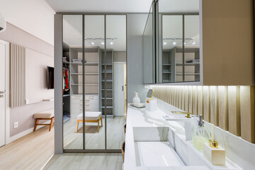 Modern entrance hall with glass partition, wood paneling and soft lighting in luxury interior design