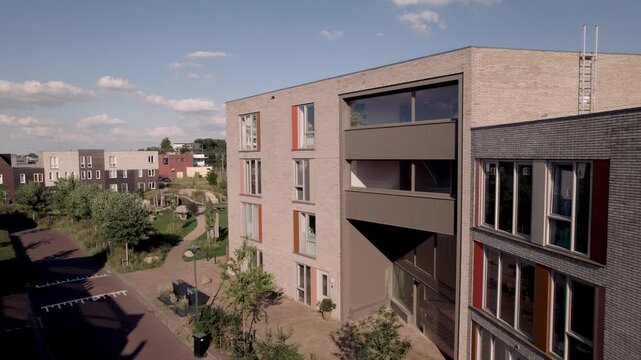 Aerial showing Dutch residential urban development contemporary housing architecture with greenery in front and behind appartment complex