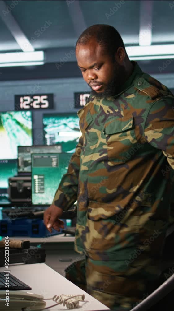 Poster vertical video intelligence corps expert in military hq base gathering information on enemy troops. 