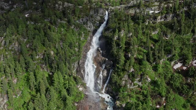 Cascate del Rutor waterfall cascading through lush green forest in the mountains