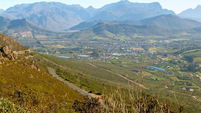 Fast white sports car race down curvy Franschhoek mountain pass, high angle view