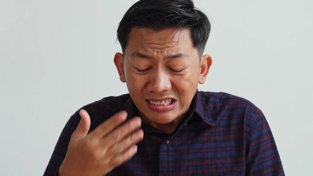 Shocked Asian Young Man Eating Hot And Spicy Food.