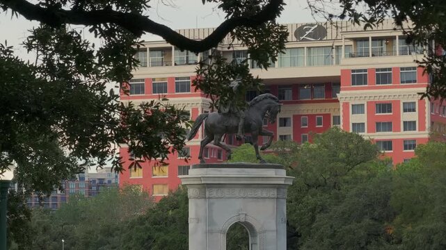 Reveal of Sam Houston Statue behind trees in Houston, TX