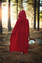 Back, child and walking with basket in forest for fairytale cosplay character or girl dress up for...