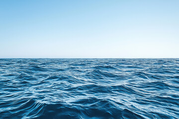 Obraz premium A breathtaking view of a serene ocean at the horizon, showcasing gentle waves under a clear blue sky that inspires peace and tranquility.