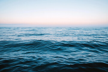 Obraz premium A Tranquil View of the Ocean's Horizon with Gentle Waves Caressed by a Soft Morning Light, Inviting Peace and Reflection
