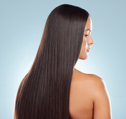 Naklejka premium Woman, straight and hair care in studio profile, keratin treatment and smooth on blue background. Female person, growth and cosmetics shampoo or conditioner for healthy scalp, clean and brazilian