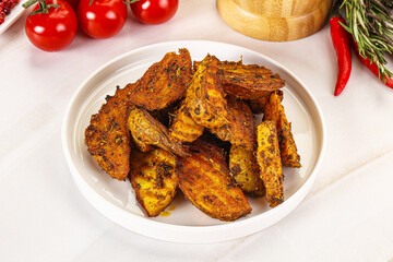 Golden baked potato Idaho with spices