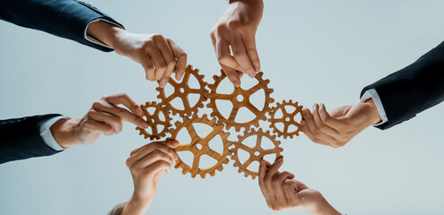 Business team joining cogwheel in circular together symbolize successful group of business...