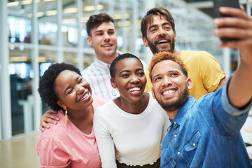Fototapeta premium People, selfie and diversity at startup, office and hug with happy, memory and profile picture at company. Men, women and group of friends with photography, solidarity and excited at creative agency