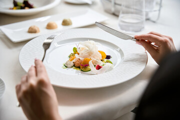 Gourmet eating and tasting food in luxury dinner party