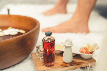 Couple indulges in blissful foot massage at luxurious spa salon for reflexology therapy in gentle day light ambiance resort or hotel foot spa. Quiescent