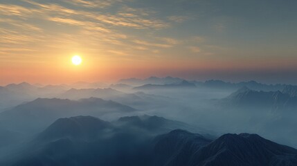 Fototapeta premium Evening fog blankets mountains under a setting sun