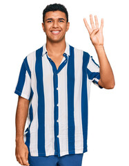 Young arab man wearing casual clothes showing and pointing up with fingers number four while smiling confident and happy.