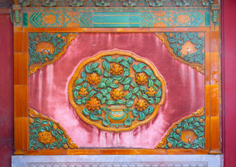 ancient Chinese glazed tile sculpture on the wall in forbidden city in Beijing