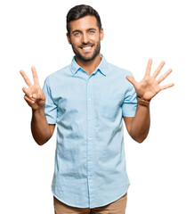 Fototapeta premium Handsome hispanic man wearing casual clothes showing and pointing up with fingers number seven while smiling confident and happy.