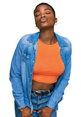 Young african american woman wearing casual clothes looking at the camera blowing a kiss on air being lovely and sexy. love expression.