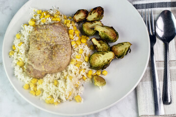 boneless pork chop  on rice with  roasted brussel sprouts