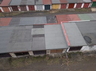 1970s east bloc old historic ruined car parking garage street lane square structure with some sprayed tags and destructed brickwork concrete facade ruin and colorful wooden door model