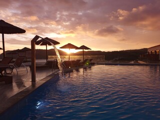 Sunset pool vacation travel umbrella water