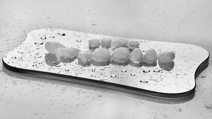 Dental veiners for upper jaws on glass with water drops on bright background in black white style © Dental Pro Content