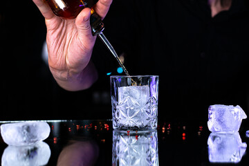 Mixologist Preparing Cocktails with Ice Cubes