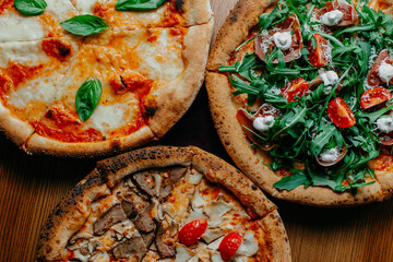 Variety of Delicious Artisan Pizzas on Wooden Table