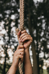 Close-Up of Hands Gripping a Rope Outdoors