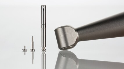 composition of dental adapter tip and pins for surgery on a white background