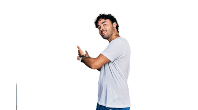 Hispanic young man with beard wearing casual white t shirt inviting to enter smiling natural with open hand